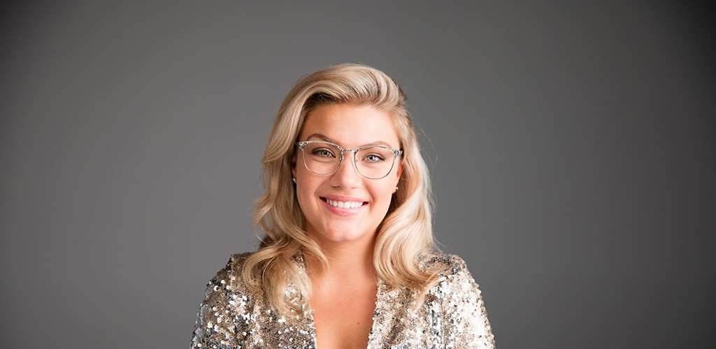 A blonde woman wearing eyeglasses
