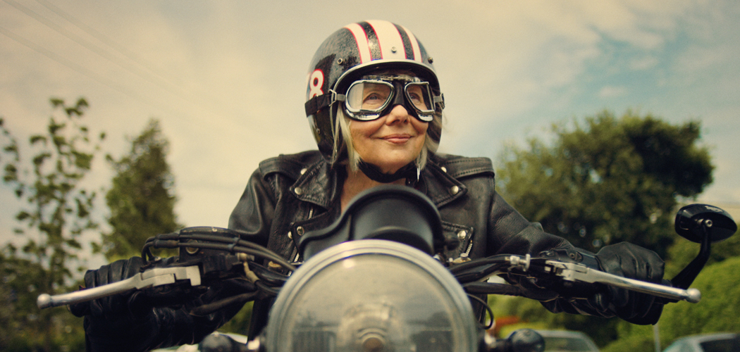 Woman wearing Air Optix multifocal drives a scooter