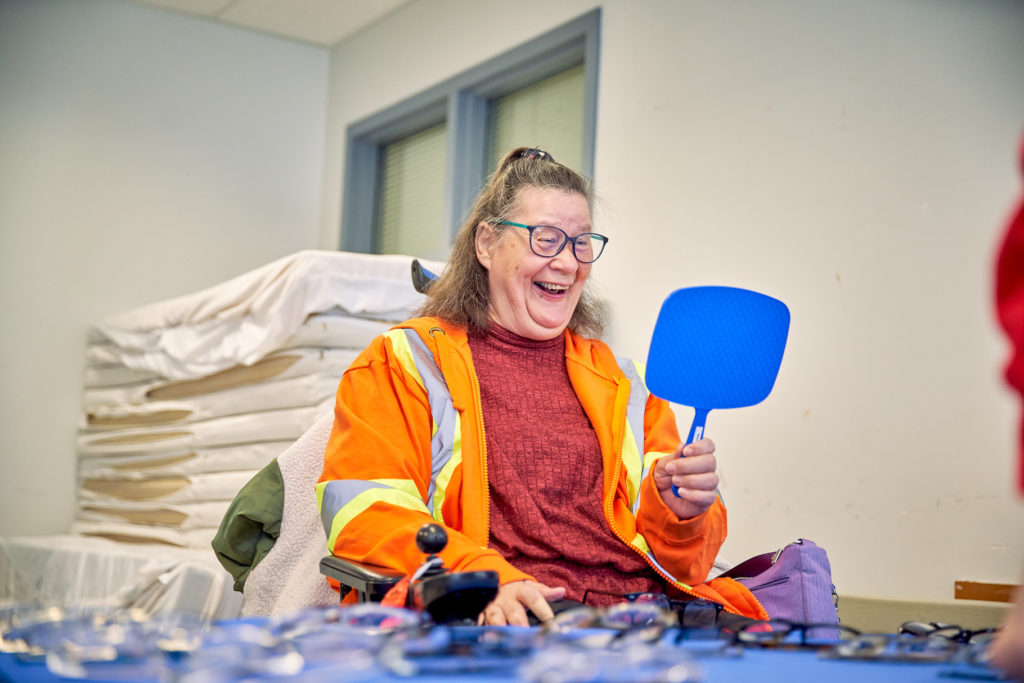 Woman wearing new glasses looking happy