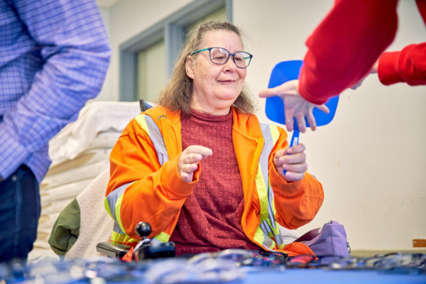 Woman looking in a mirror with a new pair of glasses