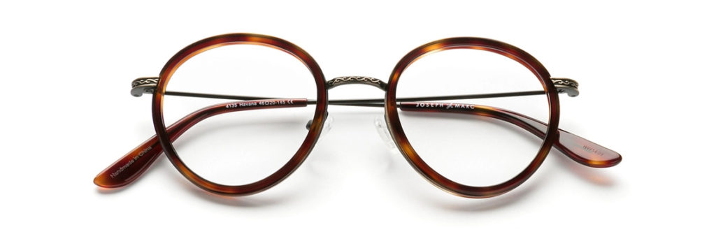 a pair of round metal tortoiseshell glasses frames with silver accents