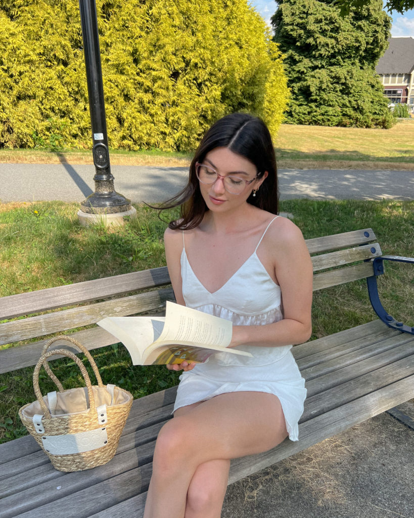 woman sitting outside wearing clear frame glasses