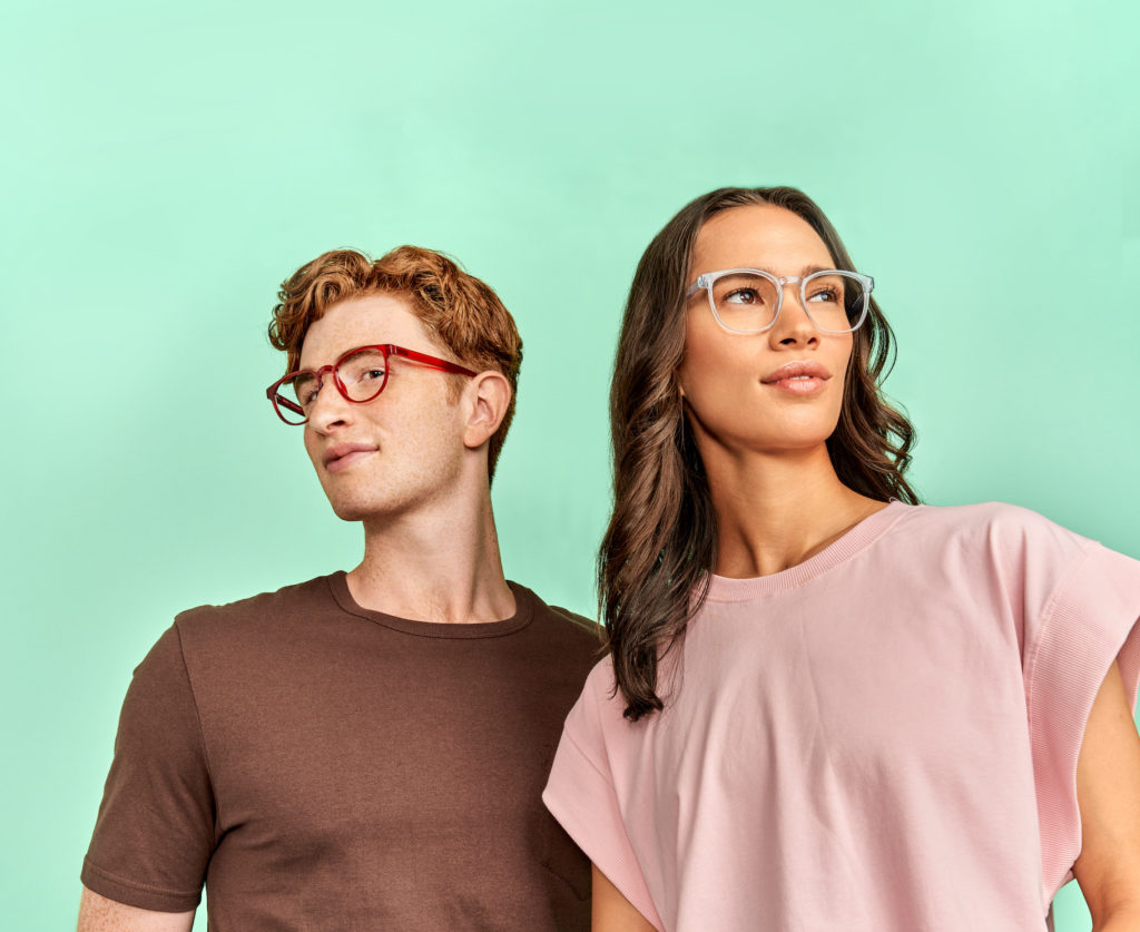 man and woman wearing sustainable clear frame glasses
