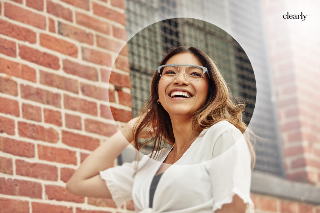 A smiling woman wearing semi-rimless eyeglasses with light blue frames